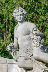 Fototapeta na wymiar Potsdam, Germany - Old statue of a sensual Renaissance era woman after bathing in the city park and gardens of Potsdam, details, closeup.