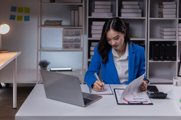 Asian business woman working late at night in office workplace. doing planning analyzing the financial report, business plan investment, finance analysis, Overtime work concept, 