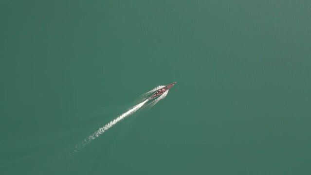 Traditional Long Boat with tourists on a Cheow Lan Lake in Kaho Sok, Thailand.