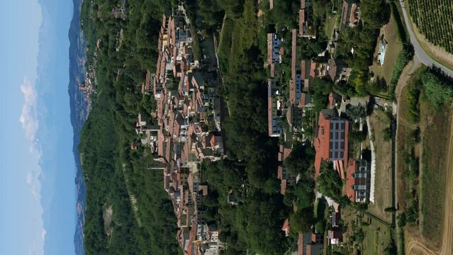 Vertical format of Rosignano Monferrato charming old town in Piedmont region of northern Italy. Aerial circling