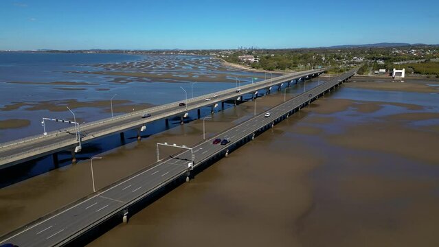 Forward moving aerial view over the Houghton Highway Bridge between Brighton and Redcliffe Peninsula, Brisbane Australia.