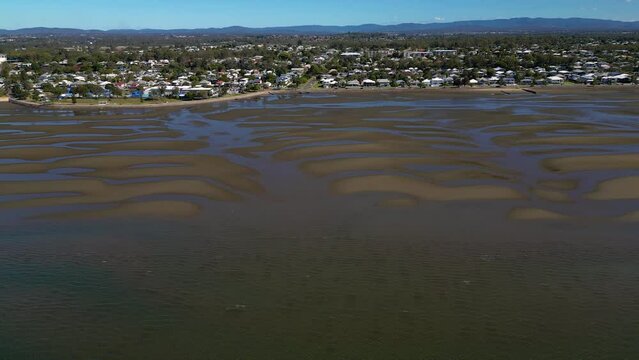 Aerial view, left to right of Sandgate and Brighton waterfront at low tide on a sunny day, Brisbane, Queensland, Australia