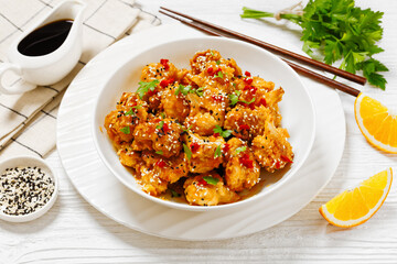 crispy orange cauliflower florets in white bowl