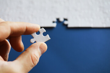 Clean puzzle elements on the background. Empty puzzle piece on the table. Teamwork concept.