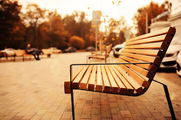 Taking a rest on a wooden bench in the park during autumn season