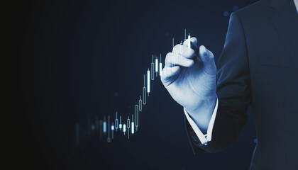 Businessman hand drawing stock market graph on virtual screen. Finance and trade concept.