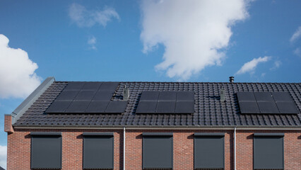 Newly build houses with solar panels attached on the roof , Solar panels on a gable roof. Beautiful, large modern house and solar energy.