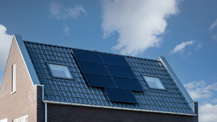 Newly build houses with solar panels attached on the roof , Photovoltaic panels on the roof