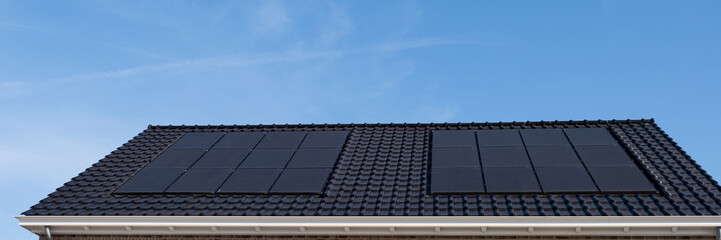 Fototapeta premium Newly build houses with solar panels attached on the roof , Solar system on a roof Own home
