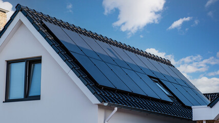 Fototapeta premium Newly build houses with solar panels attached on the roof , Solar system on a roof Own home