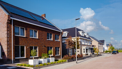 Newly build houses with solar panels attached on the roof ,Solar photovoltaic panels on a house roof