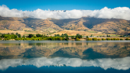lake reflection and cloudy mountains