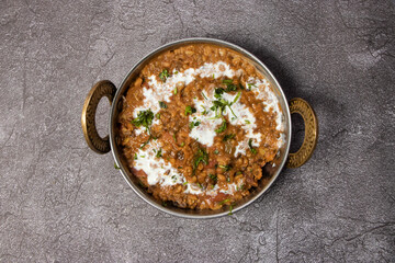 Spicy dal makhni or daal butter lentil served in karahi isolated on background top view of...