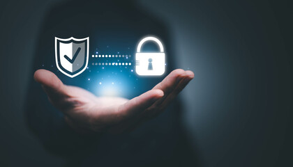 Cyber security. Business, technology, internet and networking concept. Young business man working on his laptop in the office, select the icon security on the virtual display.