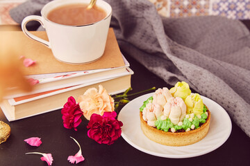 Aesthetic floral french tart among flowers. Desserts using the trend Dreamy Escapism. Pink floral cake