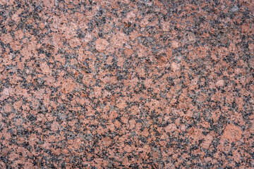 Closeup view of textured glossy pink granite slab