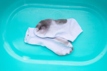 Fototapeta premium Dirty white socks in blue basin