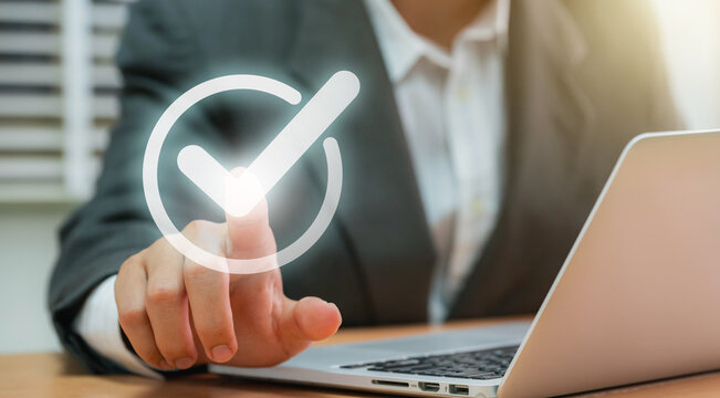 Businessmen point to tick correct sign mark in checkbox for approve quality document and project control. Excellence in document correction, ensuring quality and ISO certification for top Service
