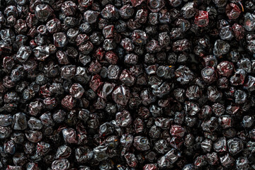 Dry wild blueberry in the background, closeup, top view, macro. A way to preserve vitamins. Vegetarian meal, healthy and useful