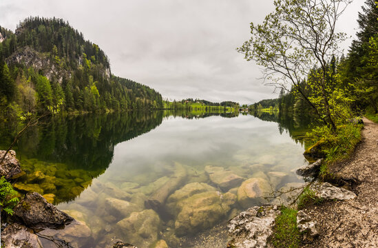 huge rocks in a mountain lake with wonderful reflections from the landscape panorama