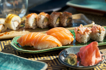 Appetizing sushi and rolls on plate