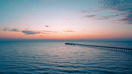 aerial drone view of oil jetty at morning sunrise over the  sea in the east of Thailand.