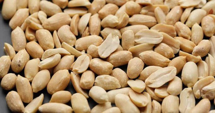 Whole shelled peanut nuts kernels close-up on sliding platform