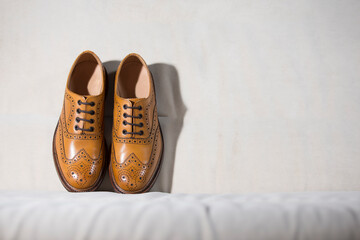 Tanned Brogue Derby Shoes Made of Calf Leather with Rubber Sole Standing Together