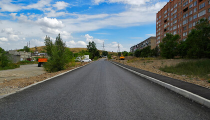 Newly built road. Road under construction. New area in the city. Apartment buildings. Ust-Kamenogorsk (kazakhstan)