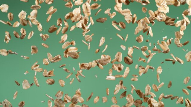 Oatmeal oats falling on green screen in slow motion