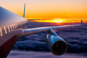 Passenger airplane is flying in the sunrise sky