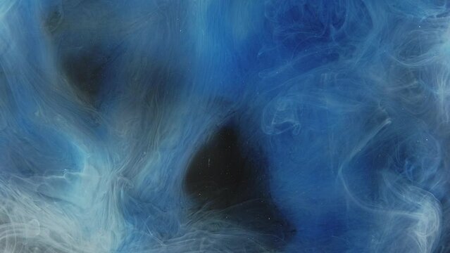 Color smoke puff. Ink water drop. Vapor splash texture. Blue fume cloud wave motion on dark black abstract art background.