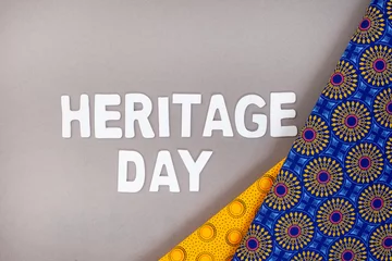 Fotobehang Heritage Day South Africa, 24th September. Heritage Day written in colorful letters with iconic South African printed cloth © Aninka