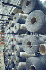 Cotton threads in industrial cotton in a weaving factory, machine weaving cotton for the fashion...