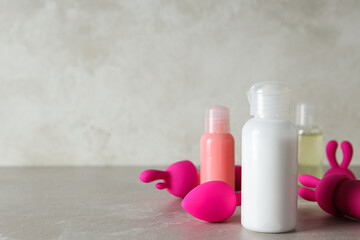Lubricant in a white bottle and toys for sex, place for text