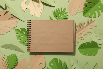 Paper green tropical leaves on a green background. With a flamingo bird.
