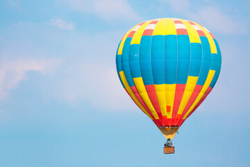 Hot air balloon against the blue sky in flight, colorful fun entertainment mode of transport. Hot air balloon flight, dream and happiness concept. Multi-colored balloon in flight.