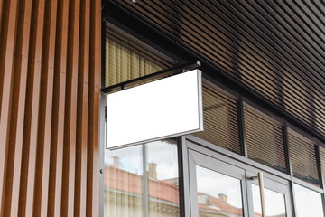 Blank white business signboard mockup. Empty illuminated shop lightbox template mounted on wall....