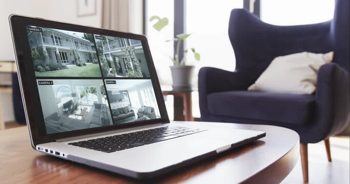 Laptop on coffee table in living room with home security camera views on screens, slow motion