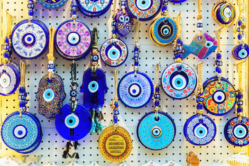 Turkish amulet Evil Eye or blue eye. Souvenir of Turkey and traditional turkish amulet (Nazar boncugu). Close up, selected focus. Travel souvenir or gift concept