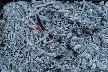 Grey coals texture background. Texture embers closeup. burning, decaying charcoal, coals,...