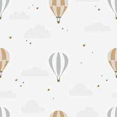 Boho seamless pattern with hot air balloons and clouds. Hand drawn balloon in the sky.Pastel neutral shades. Cute baby background. Funny decor for nursery, textiles, clothing, packaging, interior.