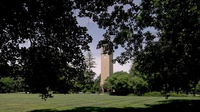Stanton Memorial Carillon Campanile on the campus of Iowa State University in Ames, Iowa with gimbal video walking forward through trees.