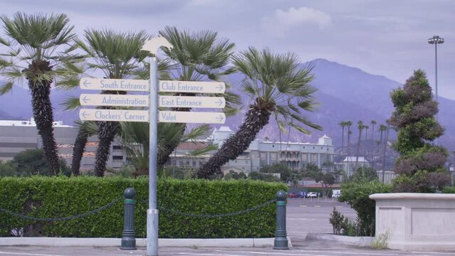 Santa Anita Park Clubhouse in Arcadia, California showing entrance signs stable shot.