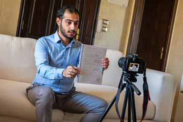 Young arabic man conducting a seminar from home