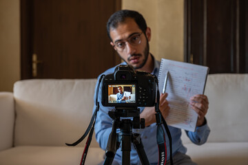 Young arabic man conducting a seminar from home
