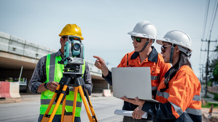 Engineers Surveyor wearing safety uniform ,helmet with equipment theodolite to measurement...