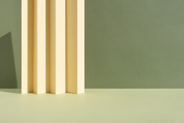 Abstract green background for the presentation of a cosmetic product. A scene with a geometric beige backdrop. Podium for product promotion, beauty, natural eco cosmetic.