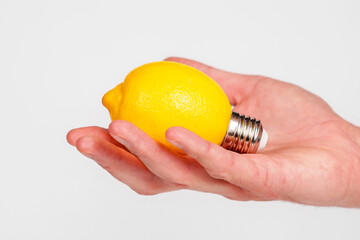 Creative lemon light bulb in hand. Conceptual energy idea © Pavel Iarunichev