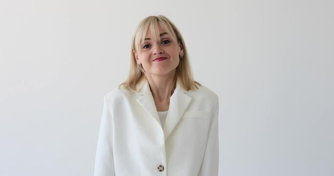 Woman on a clean white backdrop, expressing confusion and uncertainty by shrugging her shoulders. Her facial expression and body language reflect her puzzlement and inability to find an answer.